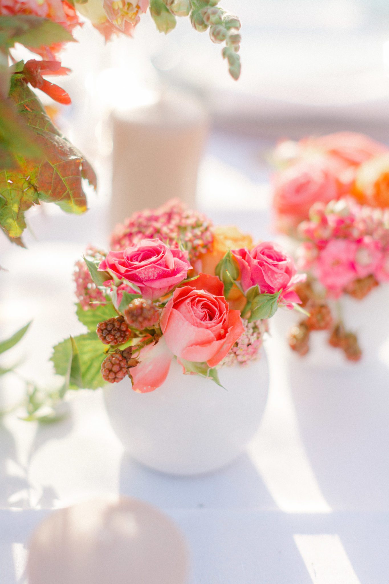 Pink, orange and red vibrant florals for your wedding centrepieces