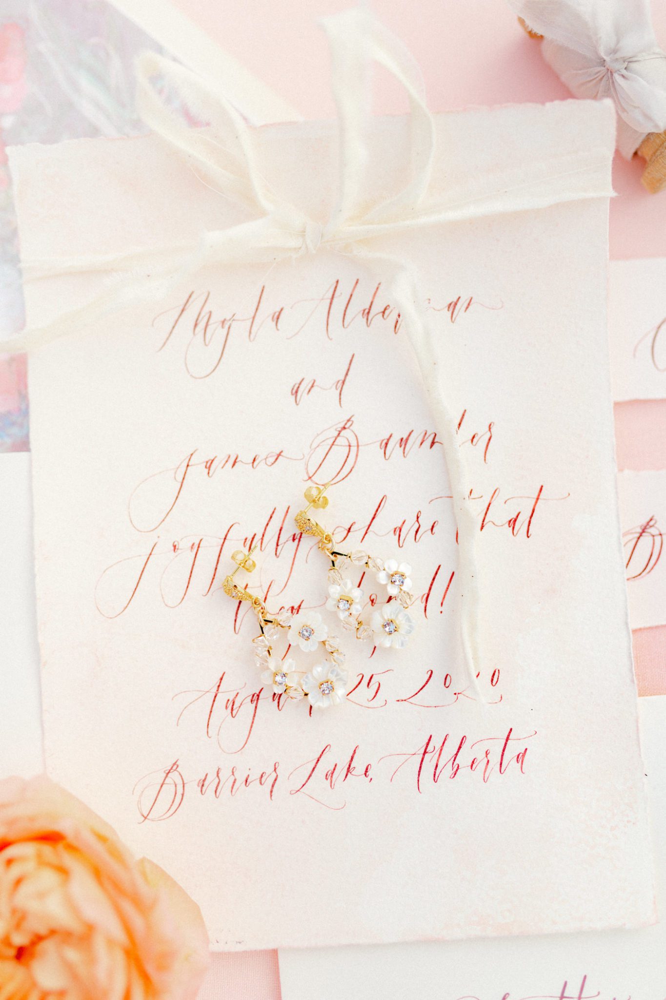 Romantic pink wedding stationery inspiration with white ribbon