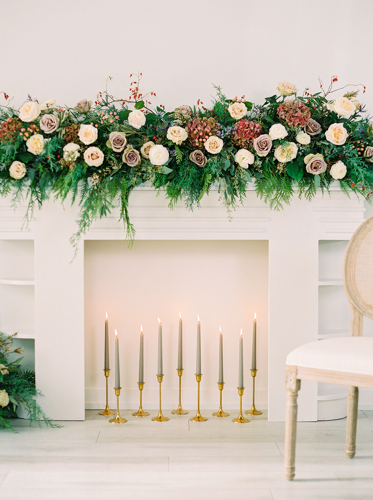White faux fireplace with gorgeous winter floral mantle piece