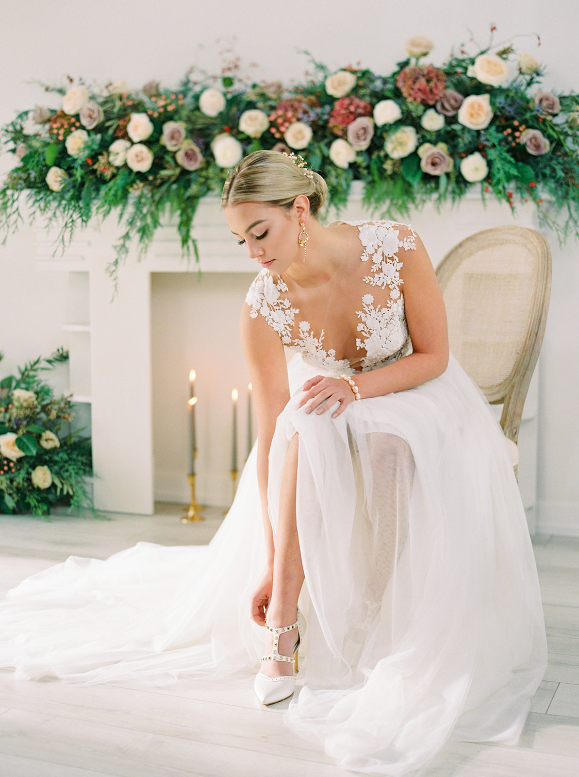 Elegant bride puts on her white high heels
