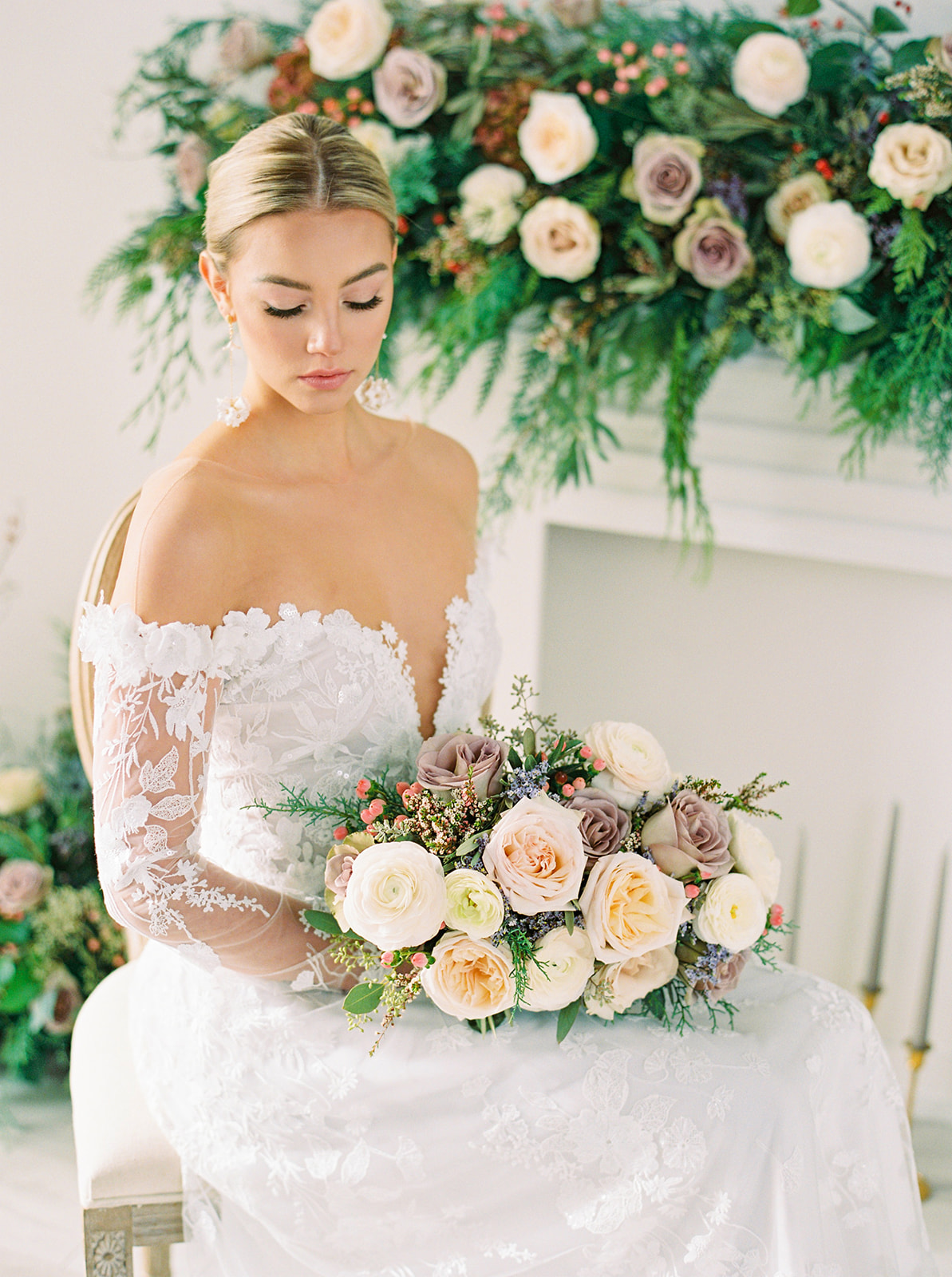 Off the shoulder gown with white lace details and a winter wedding bouquet