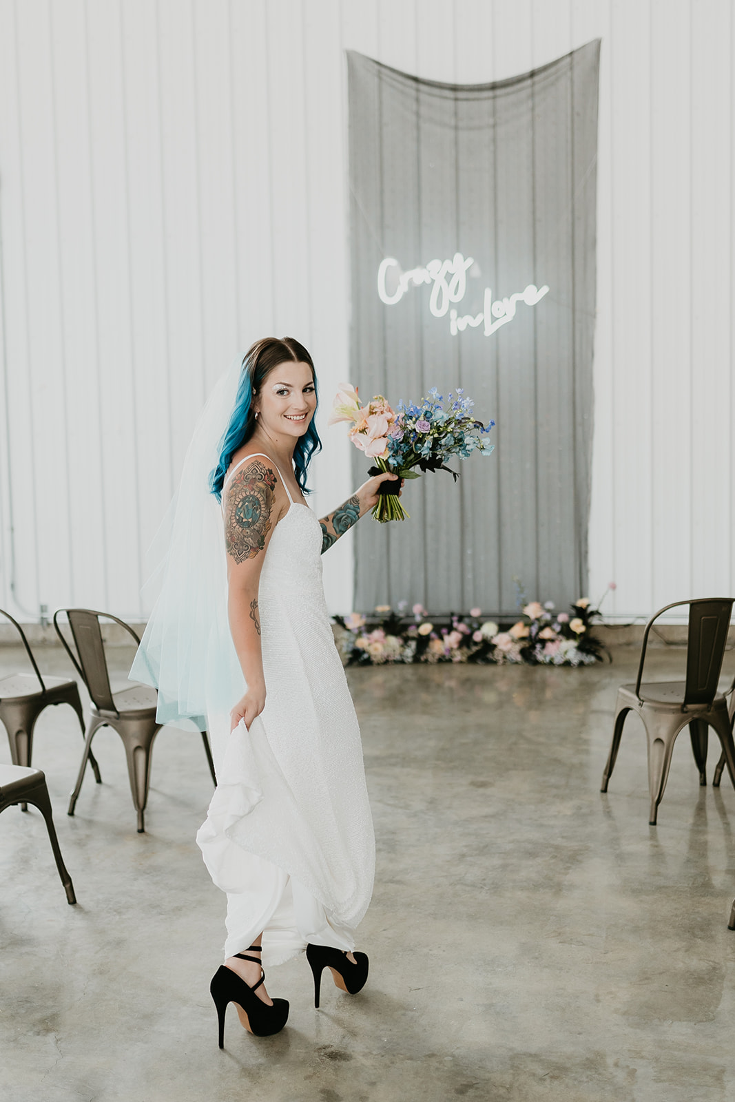 Blue haired bride with tattoos and bright colourful florals