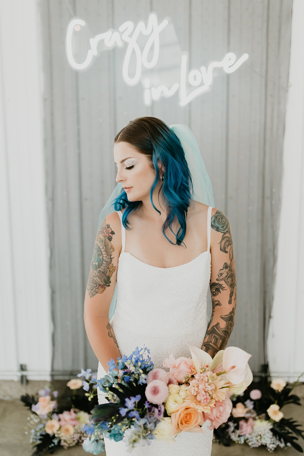 Blue haired rocker bride with a blue veil