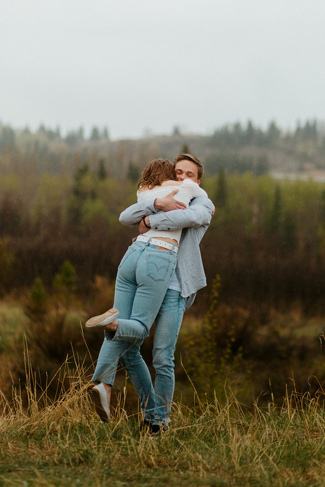 Adorable couple in denim photographed in the pouring rain