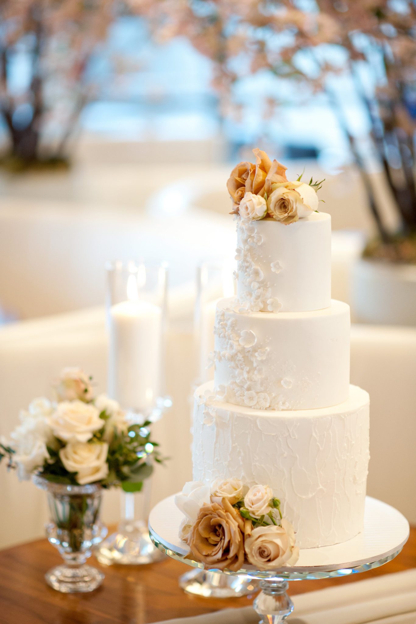 Classic and elegant white wedding cake with floral details