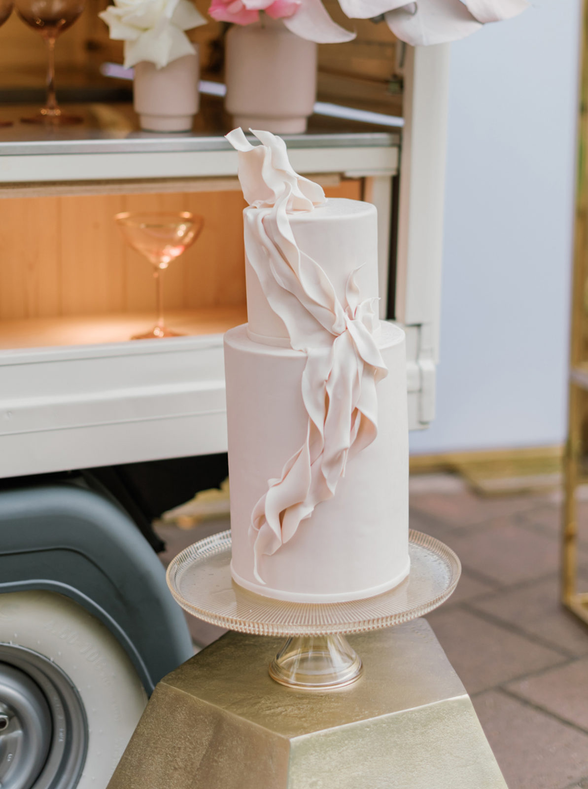 Towering blush two tiered fondant wedding cake