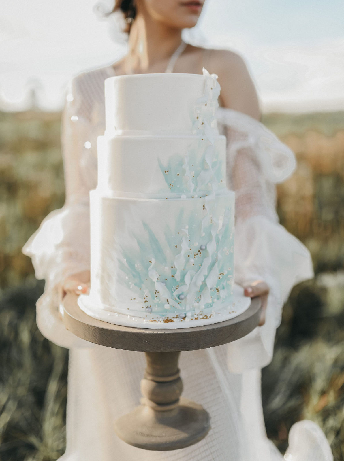 Ocean inspired wedding cake with tiffany blue waves and gold details