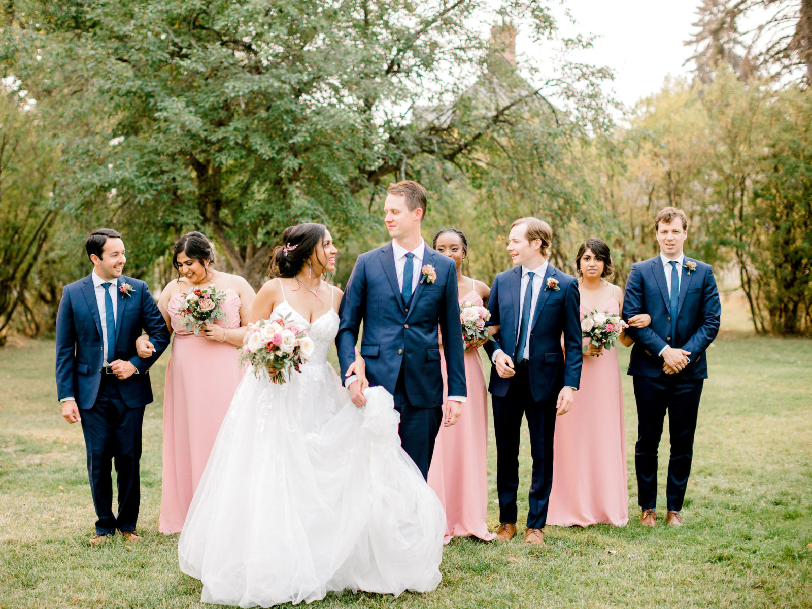 Blush and navy wedding colour inspiration with bridesmaid in blush gowns and groomsmen in navy suits