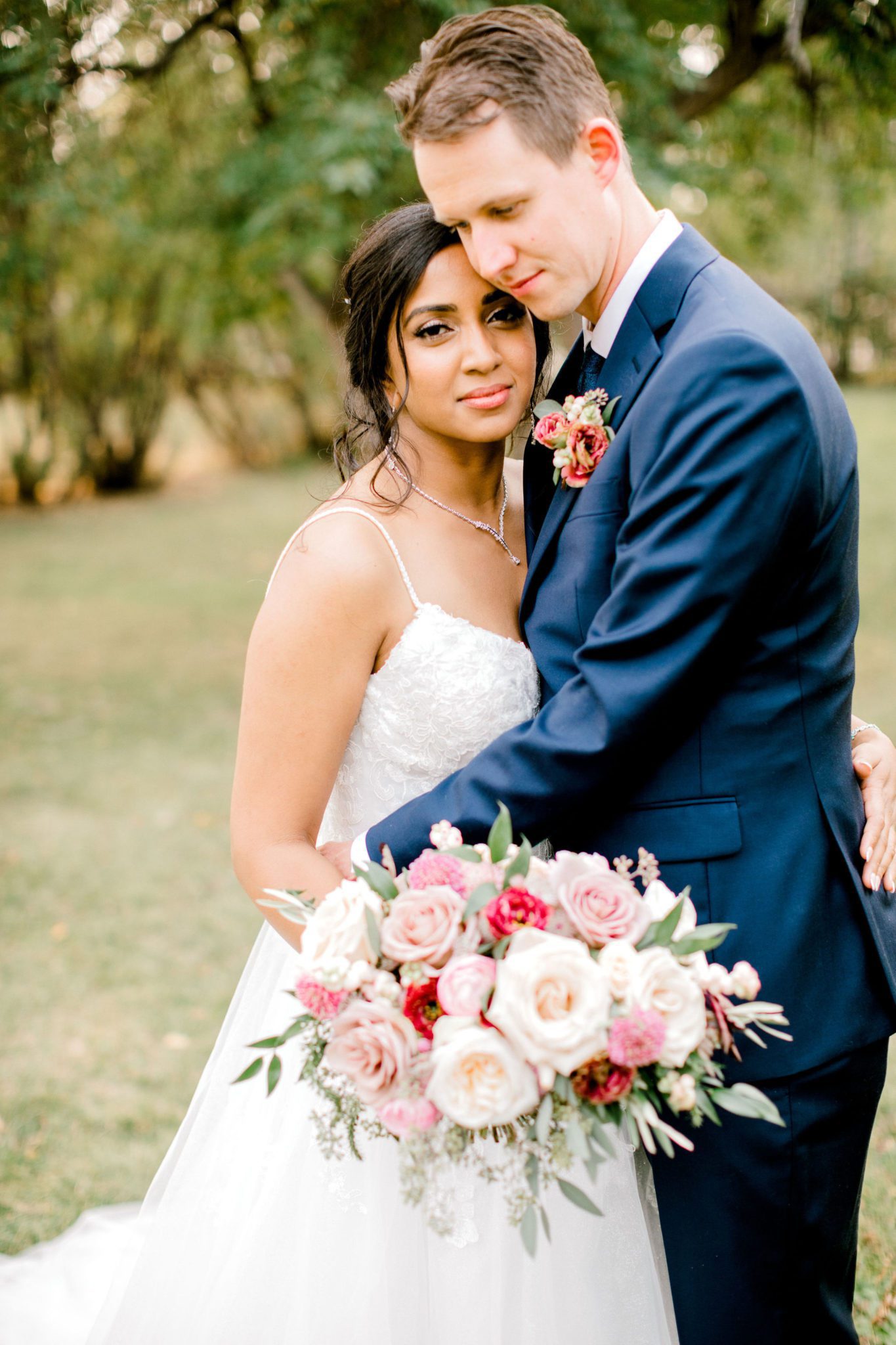 Romantic portrait of bride and groom with a stunning pink, blush and white bridal bouquet
