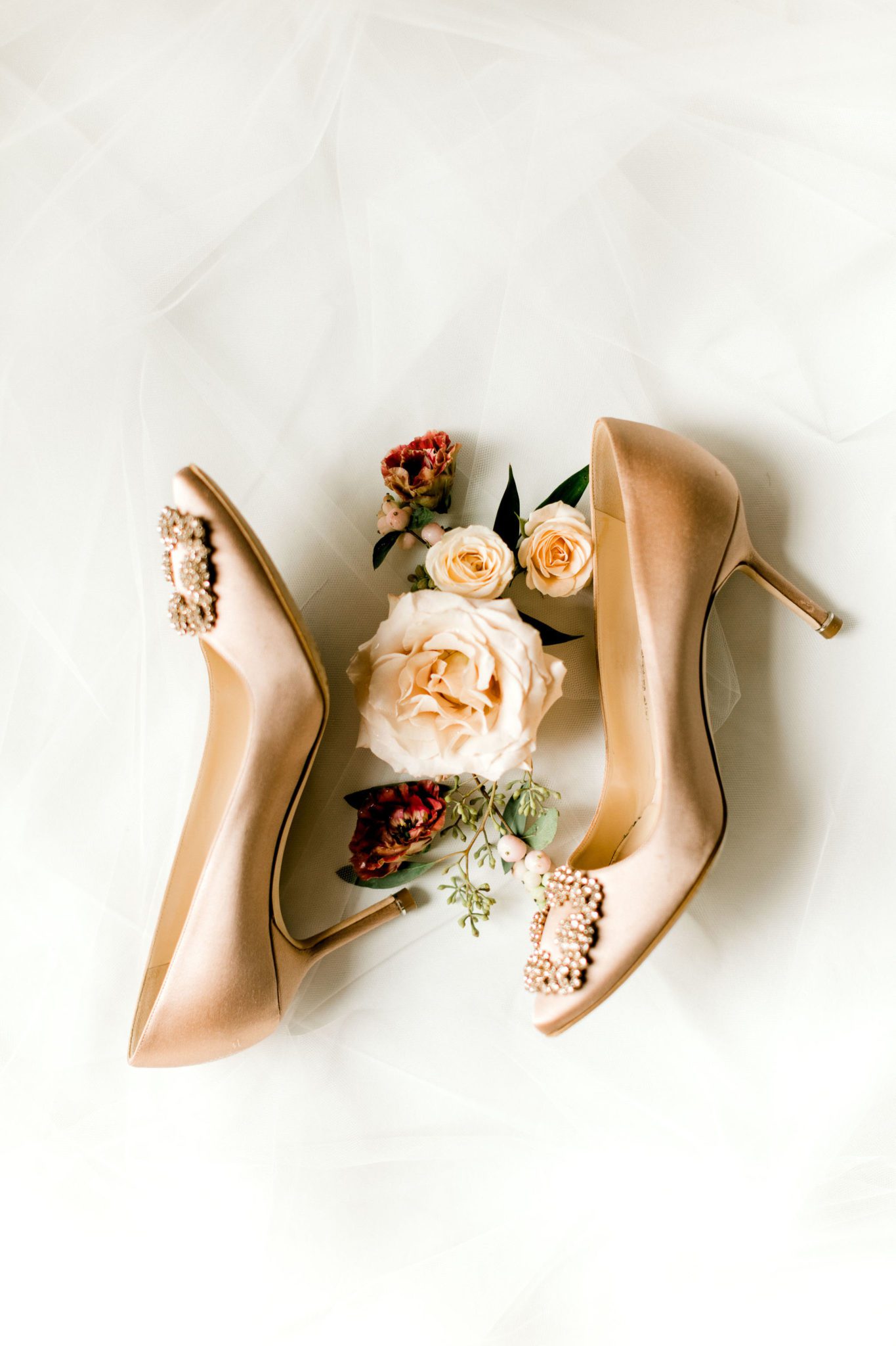 Gold bridal high heels pictured with flay lay details and florals