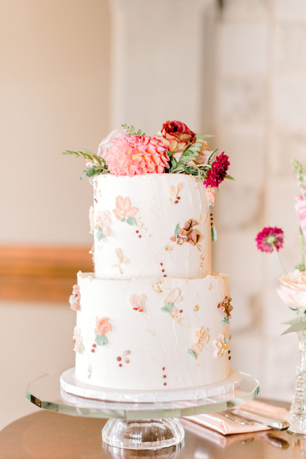 Stunning flower inspired two-tiered wedding cake in blush and pink hues