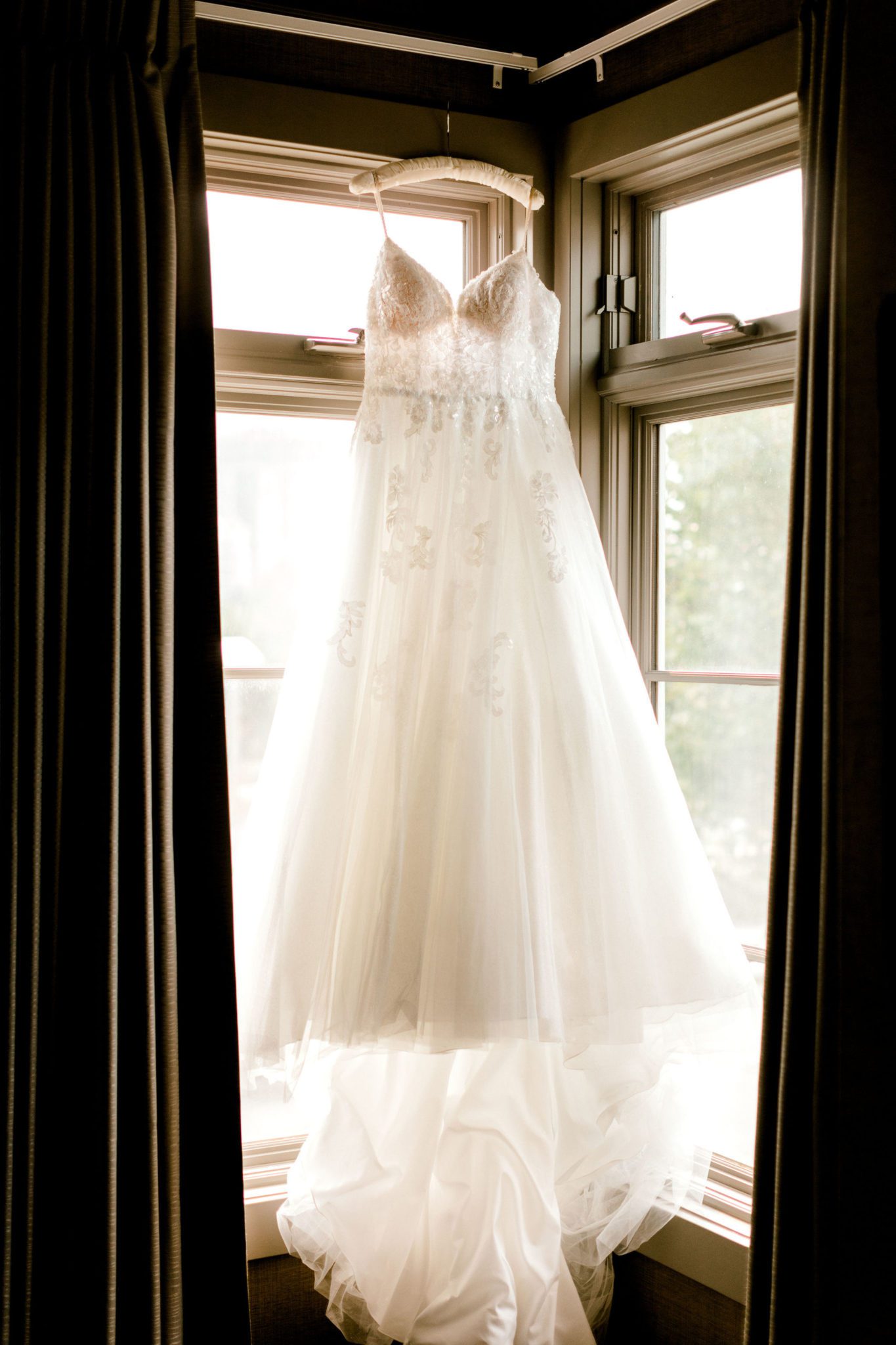 Flowing wedding gown silhouette in a window