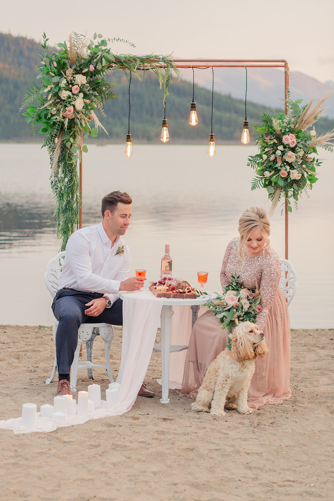 Bride and groom with their intimate and romantic decor for their lakeside elopement