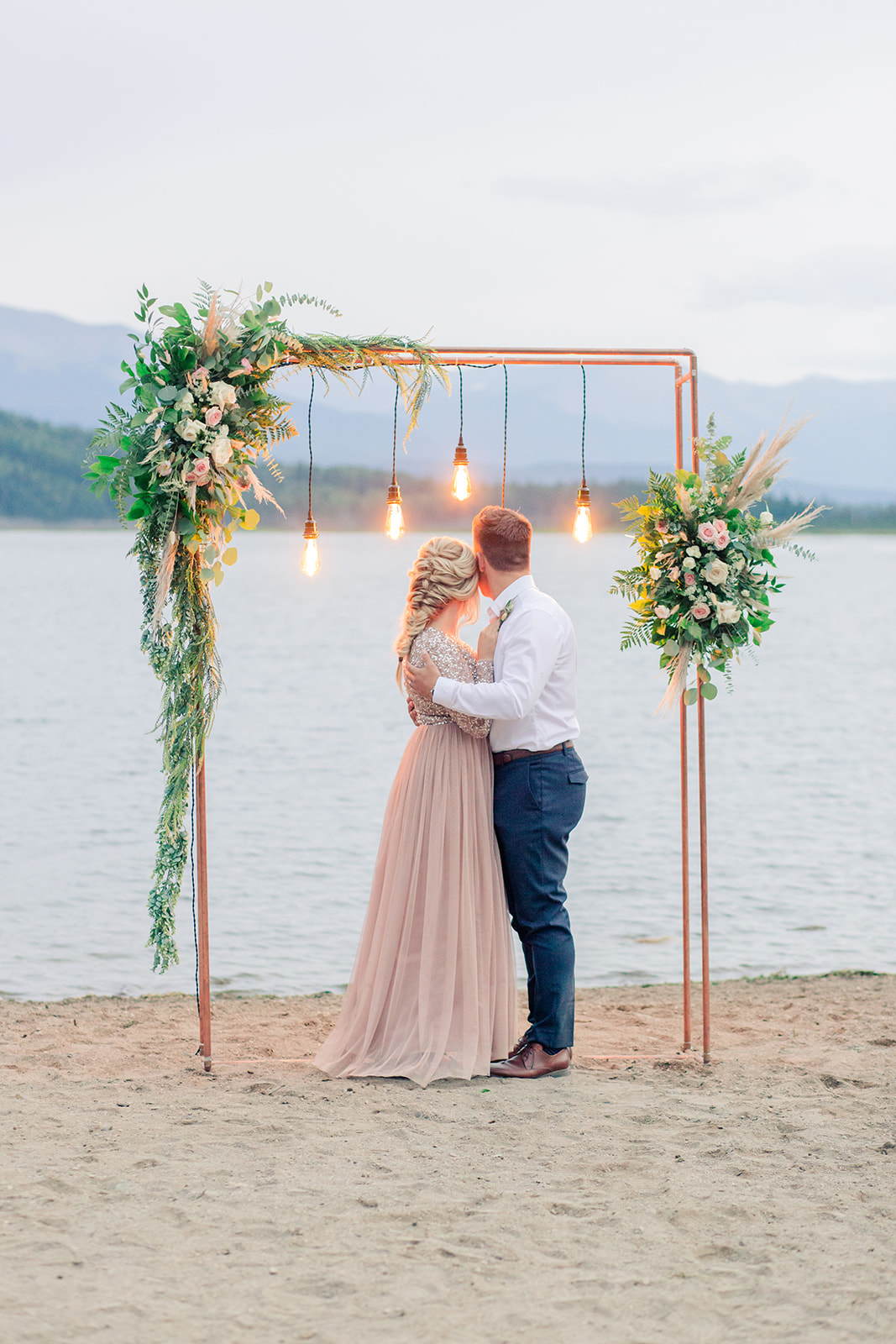 Intimate wedding decor and industrial lighting for this lakeside elopement with blush and gold hues