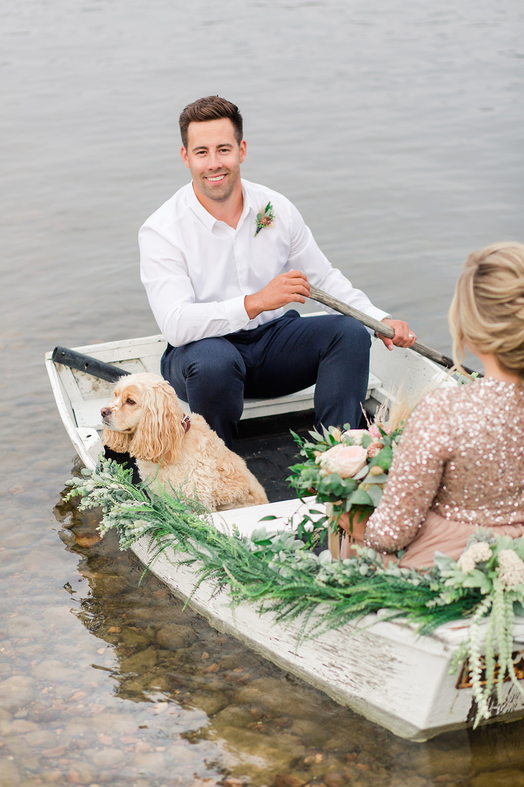 Lakeside elopement inspiration for the stylish couple with a rowboat and their spaniel