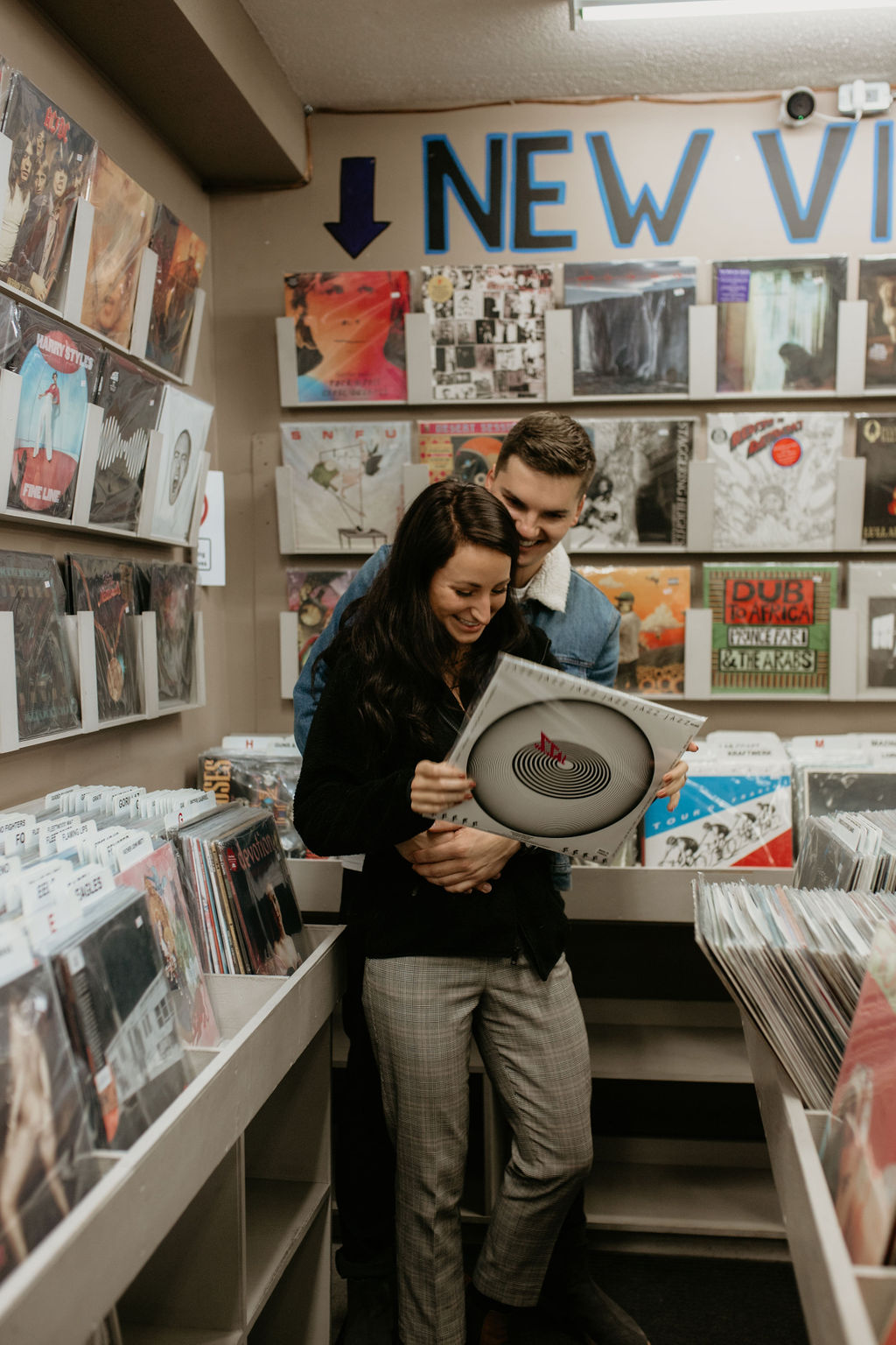Couple browses through records during their Recordland engagement session