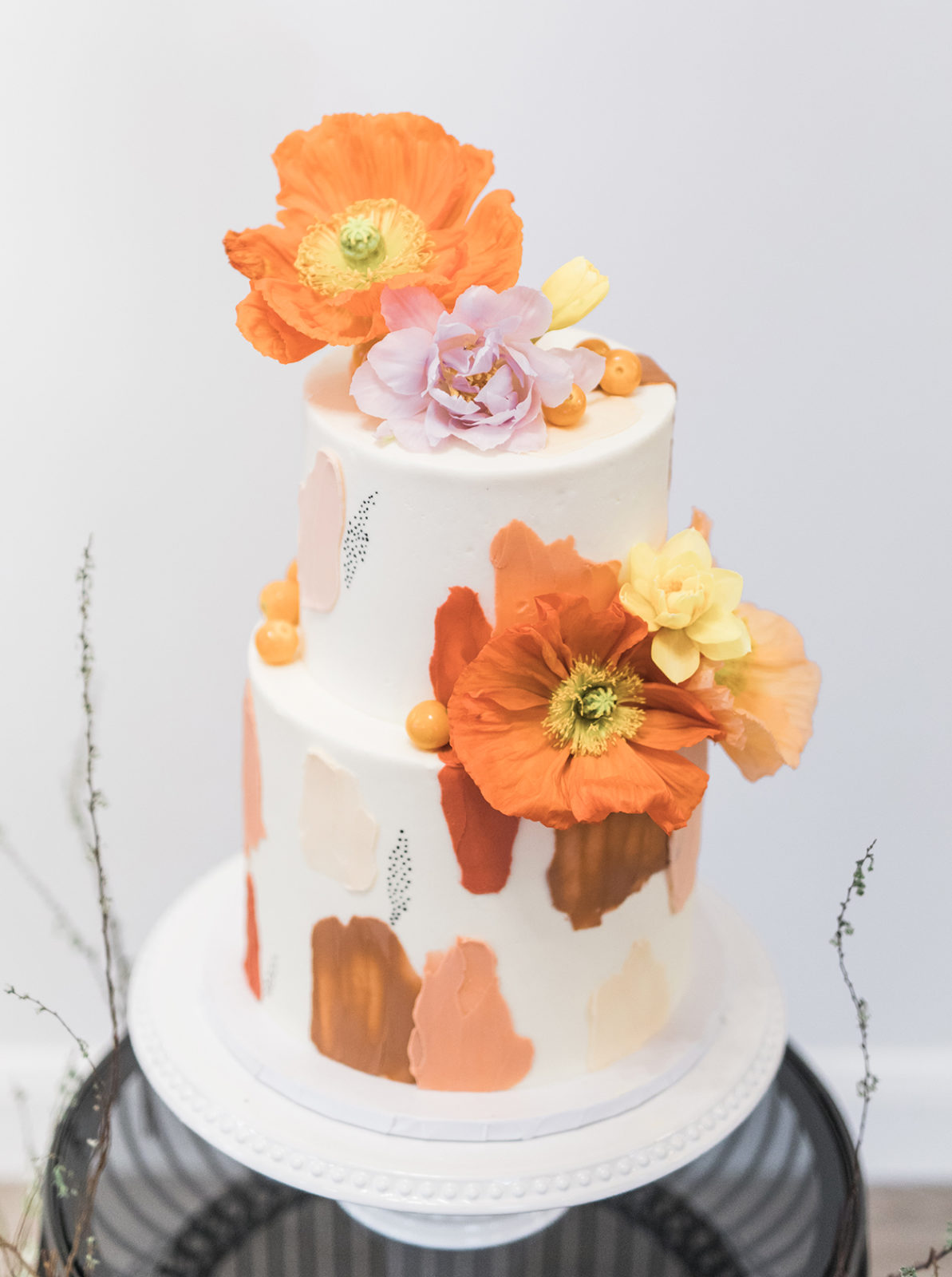 Colourful bright poppy inspired wedding cake with bright tangerine sugar flowers