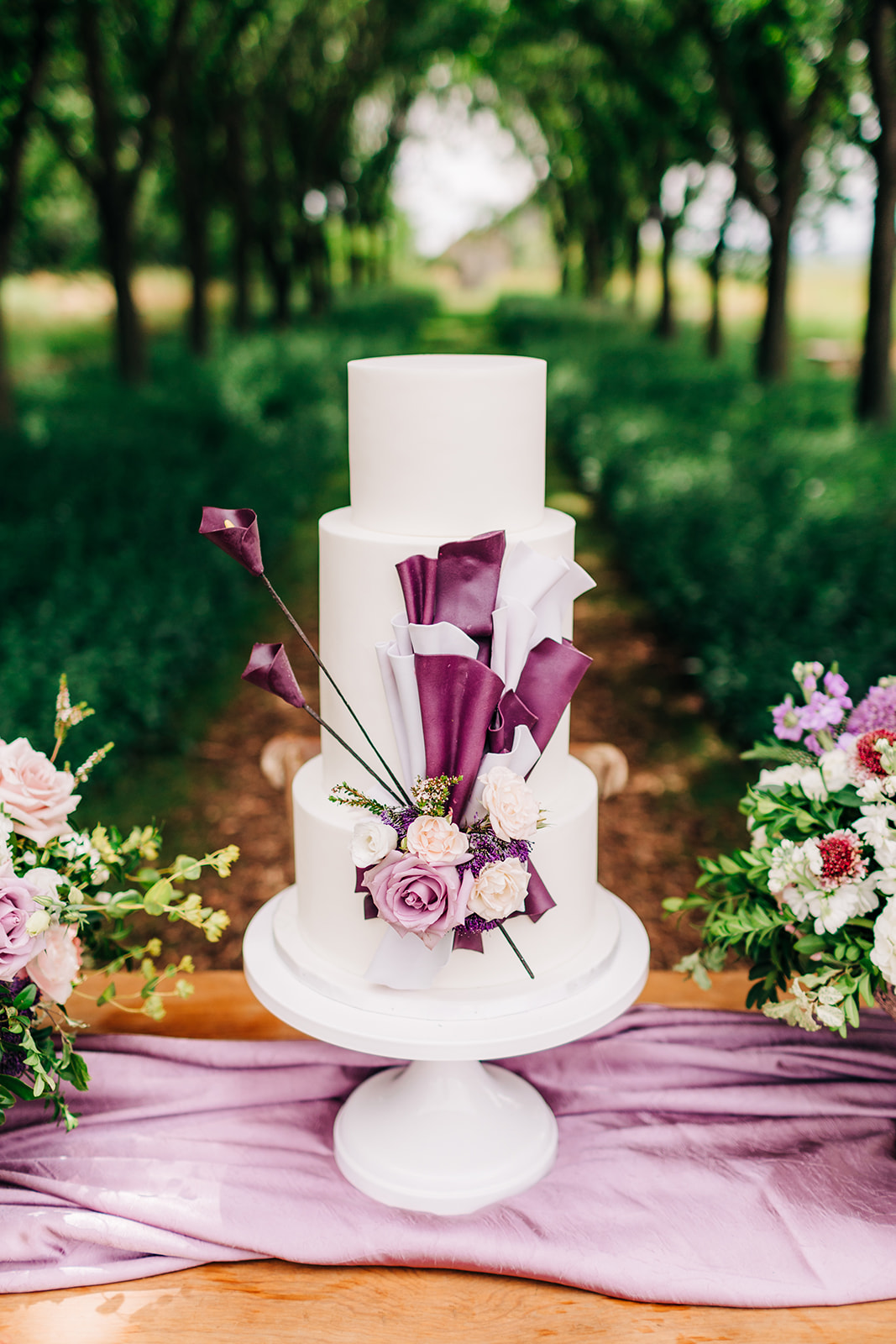 show-stopping wedding cake with purple and white floral cake with vibrant purple flowers