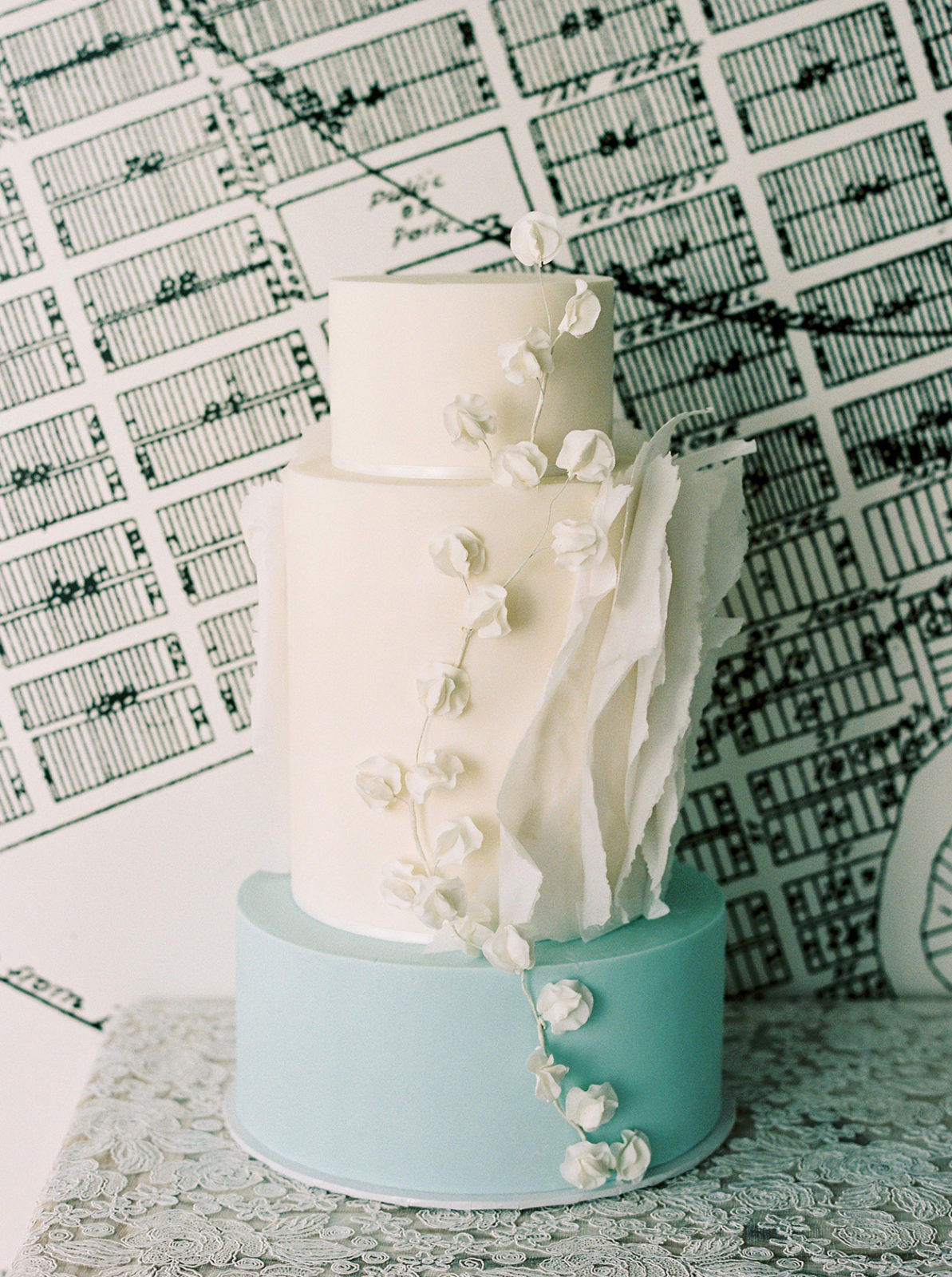 Show-stopping blue and white wedding cake with floral details