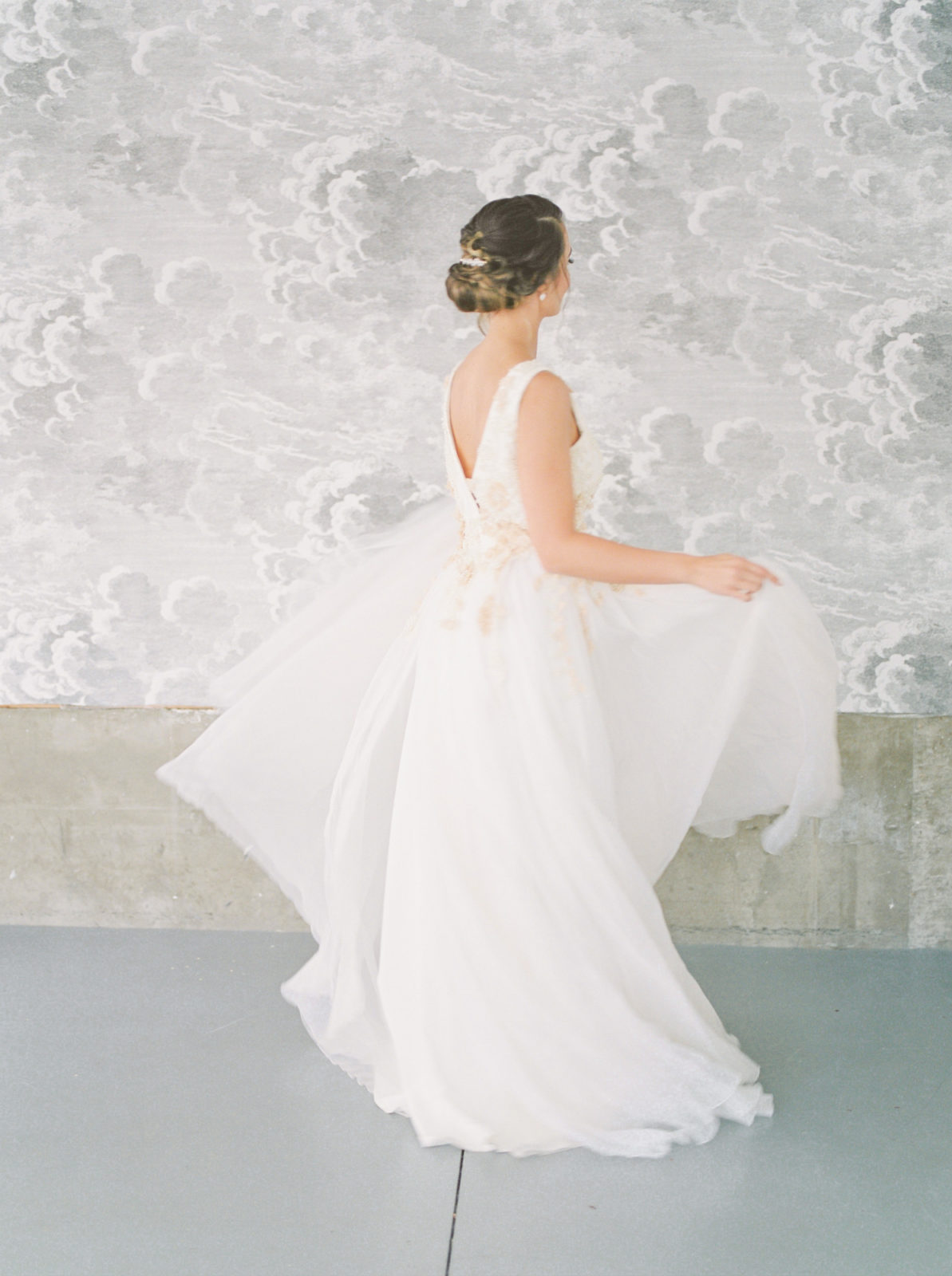 Whimsical and romantic bride in a Kathryn Bass gown