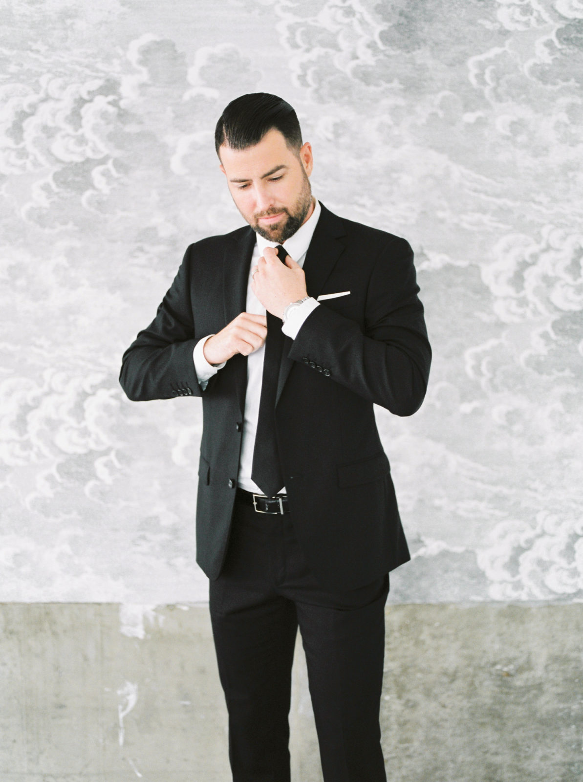 Groom attire inspiration in a classic black suit