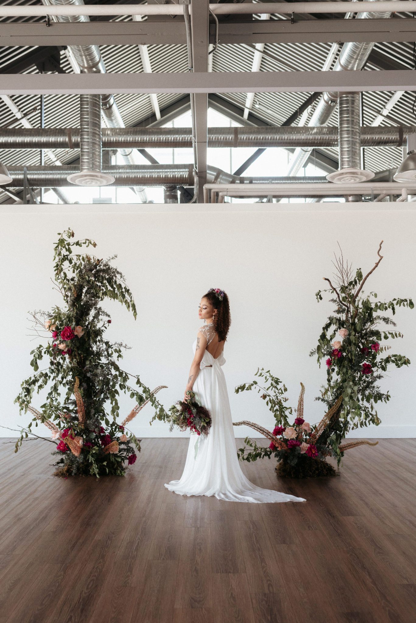 Asymmetrical plum and olive floral arch for moody at Wallace Venue Wedding