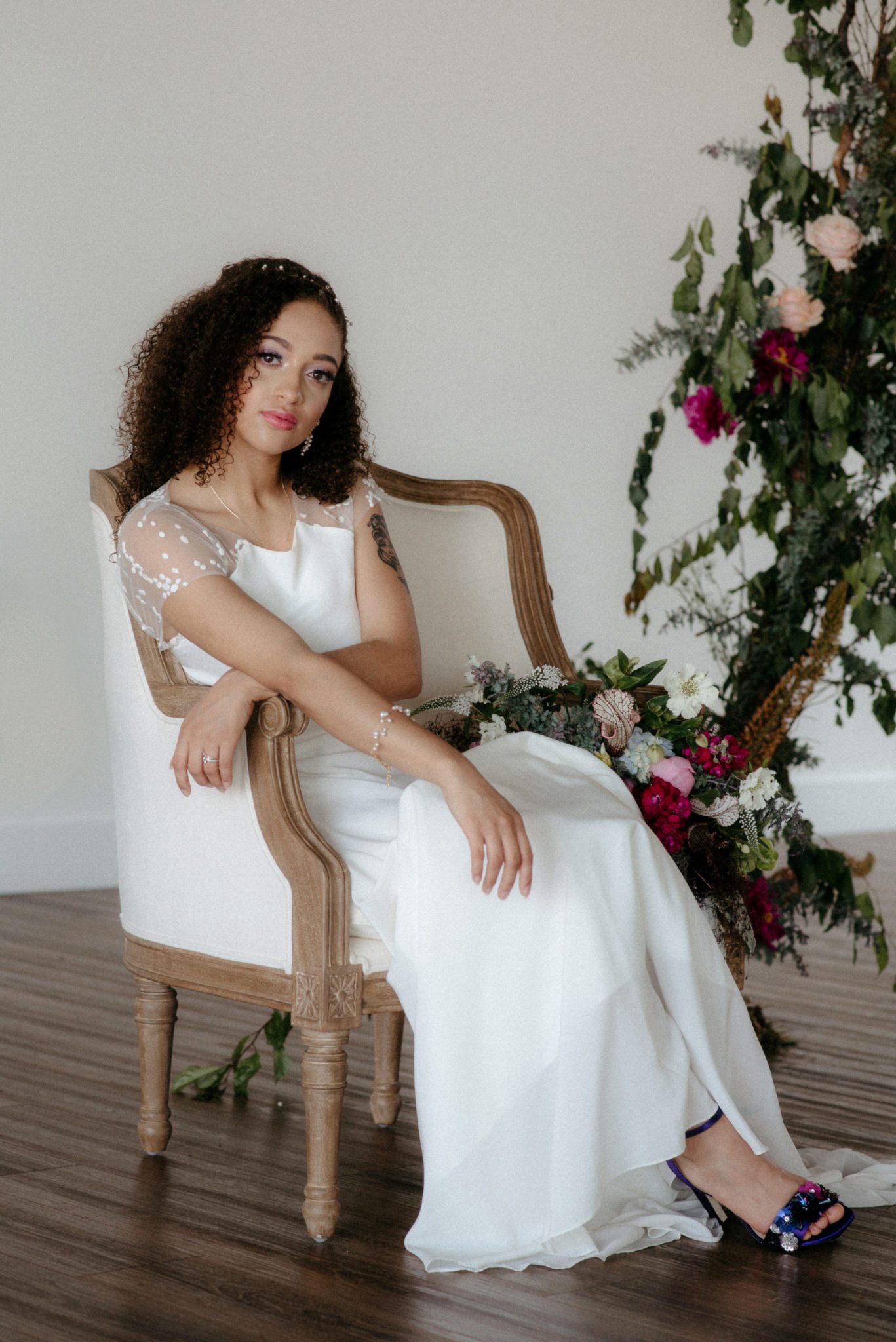 Bride seated in antique chair at Wallace Venue
