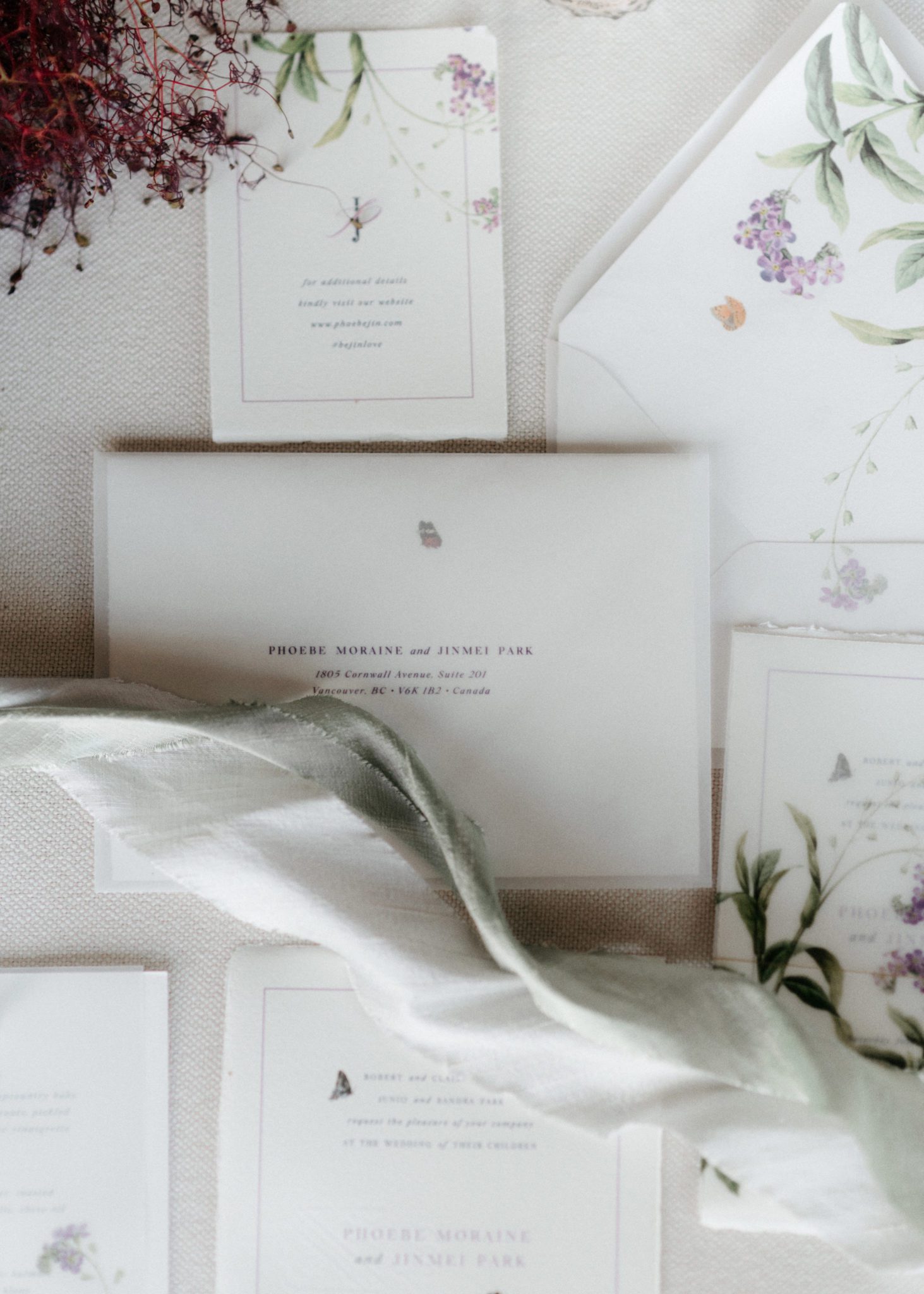 Purple and olive wedding stationery flat lay