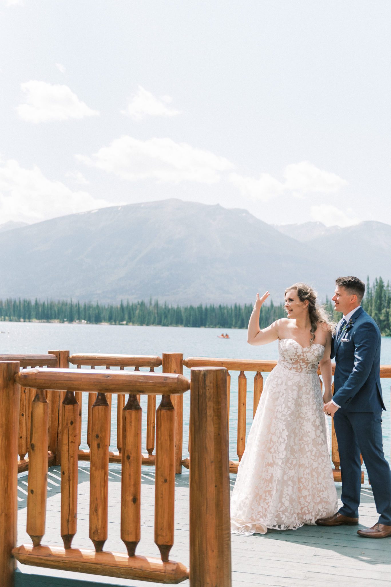 Couple waves to onlookers after their intimate mountain elopement at the Fairmont Jasper Park Lodge