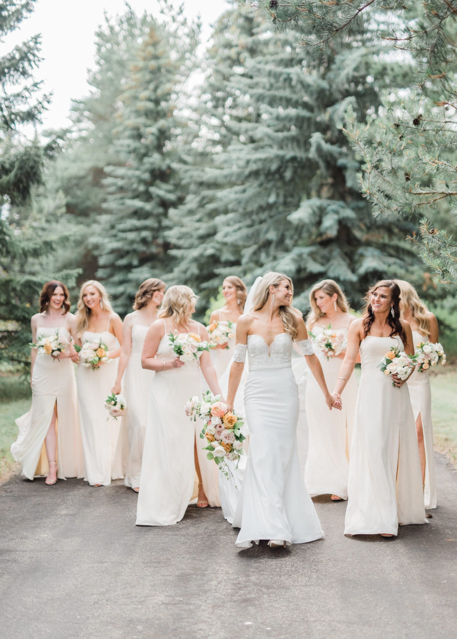 Bridesmaids in cream and blush bridesmaid gowns