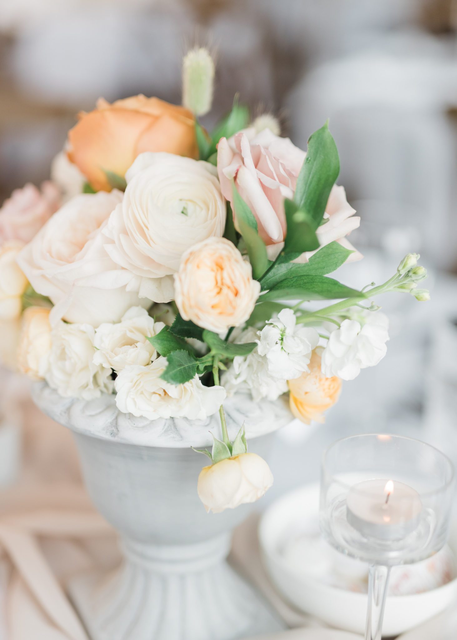Cream, peach and white wedding floral arrangements for your reception