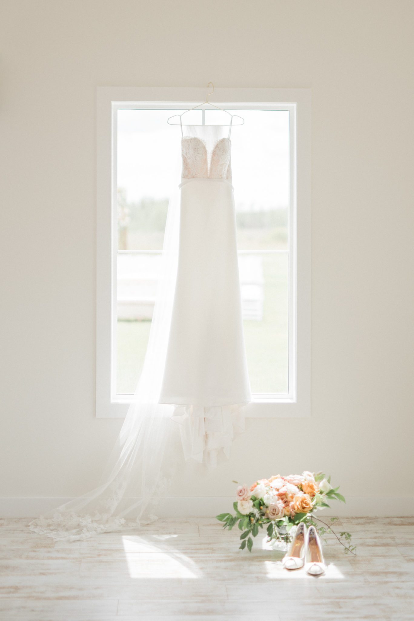Wedding gown hangs in the window at the Barn at Wind's Edge in Saskatchewan