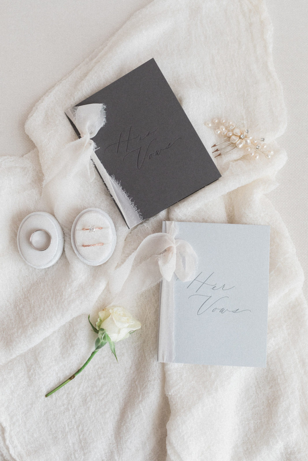 His and her vow books photographed with monochromatic details