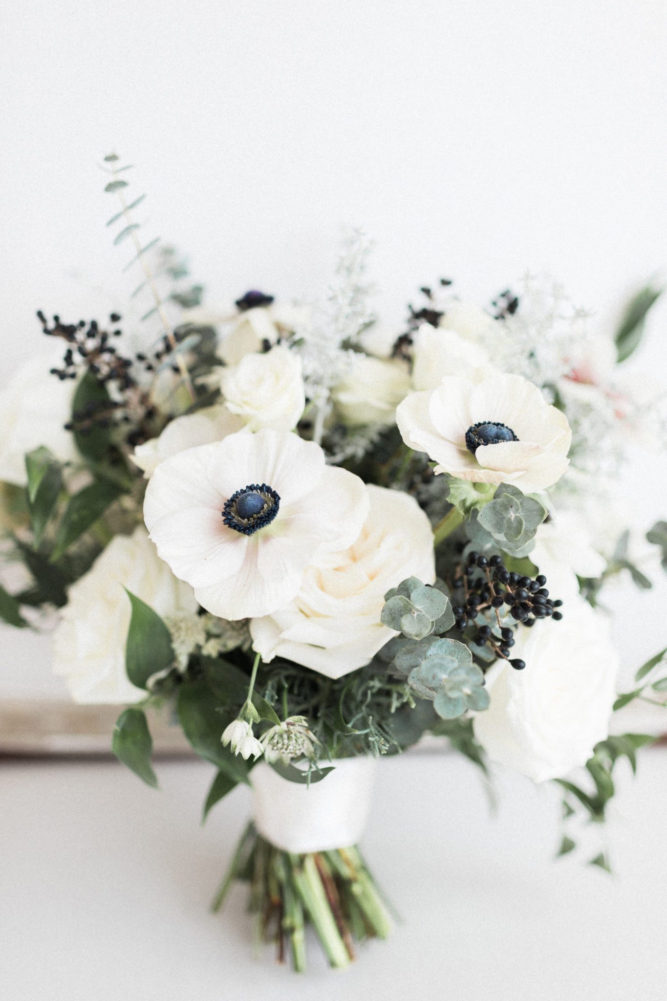 Monochromatic bridal bouquet with anemonastrum