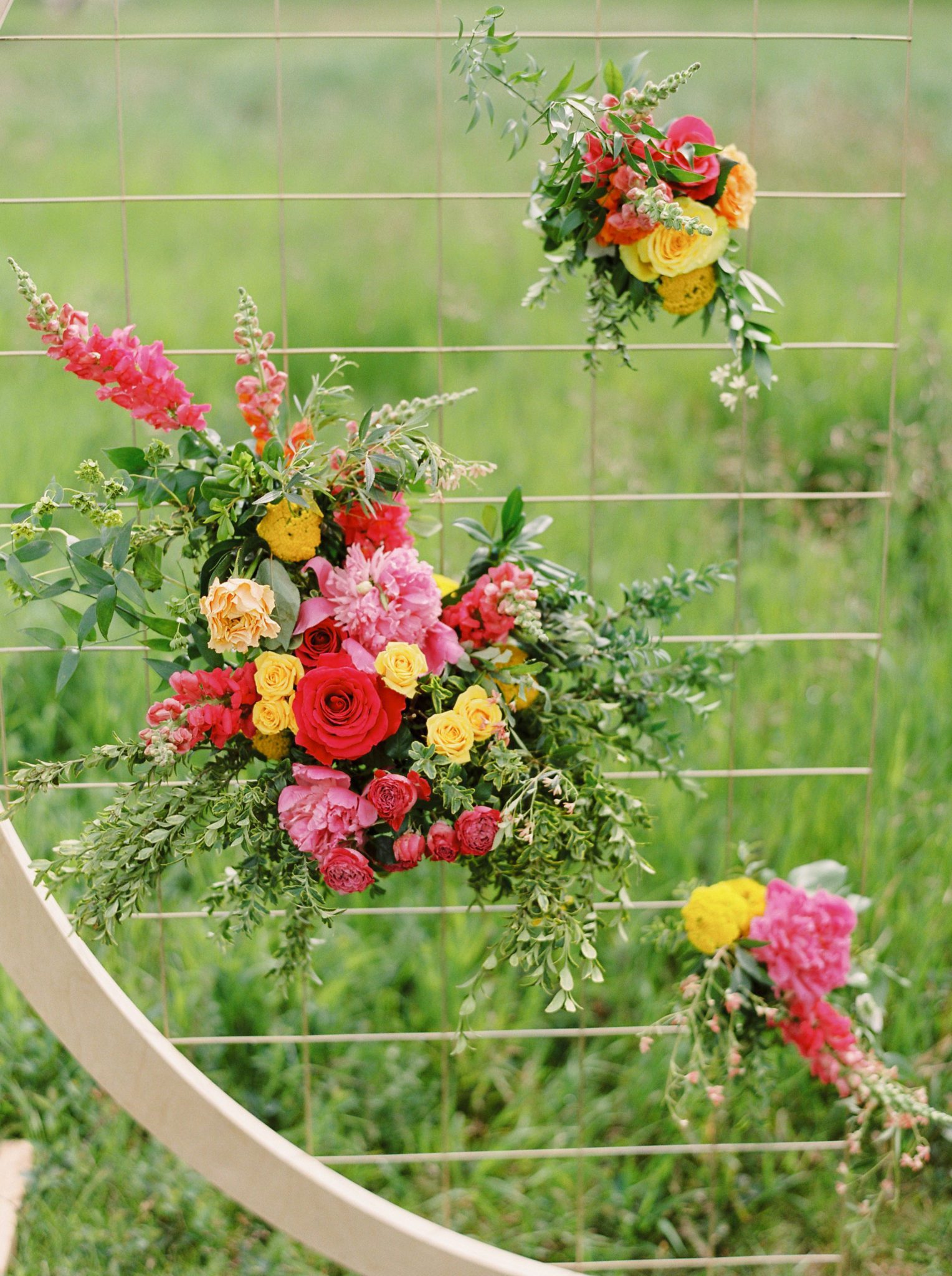 Farmhouse Chic: A Vibrant Wedding Inspiration Shoot at the Gathered | Brontë Bride Blog - Modern Wedding Arch with Bright Colourful Flowers
