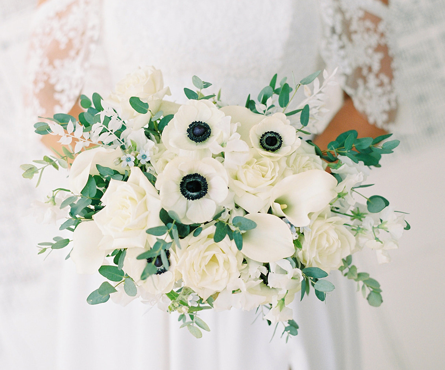 White wedding bouquet with anemones and white roses 