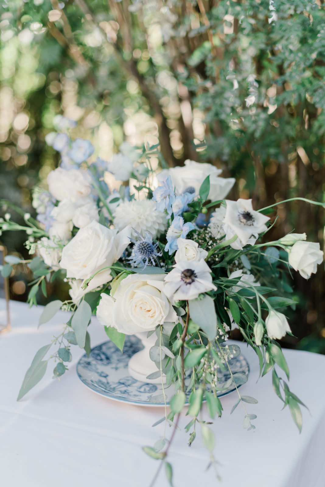 White and blue wedding reception floral arrangement