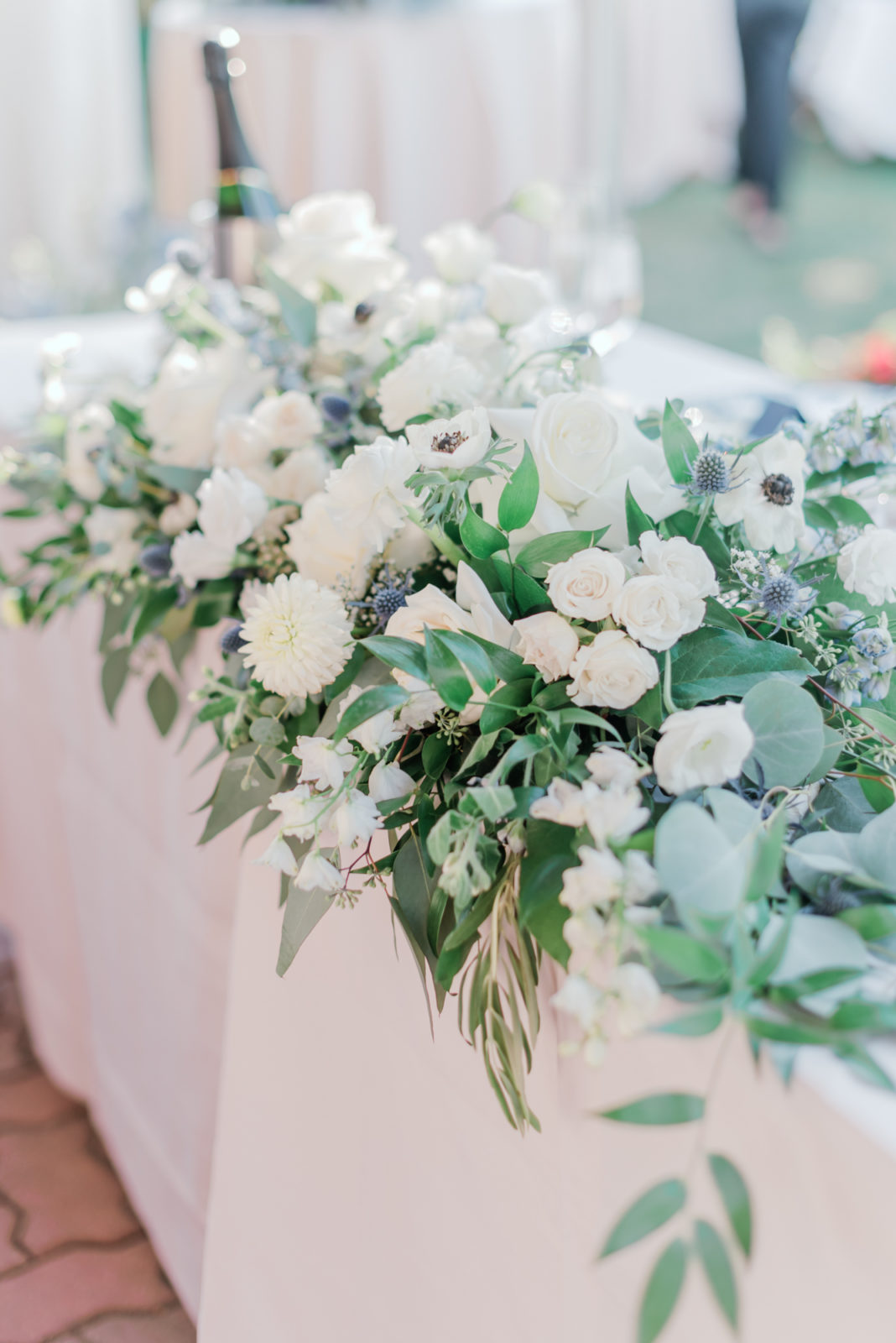 White and pale blue blooms for wedding reception floral arrangement