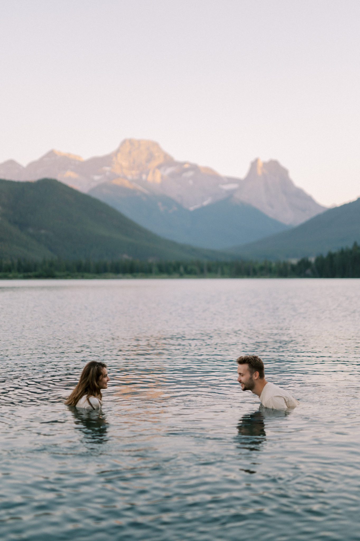 Couples session in a lake at sunset
