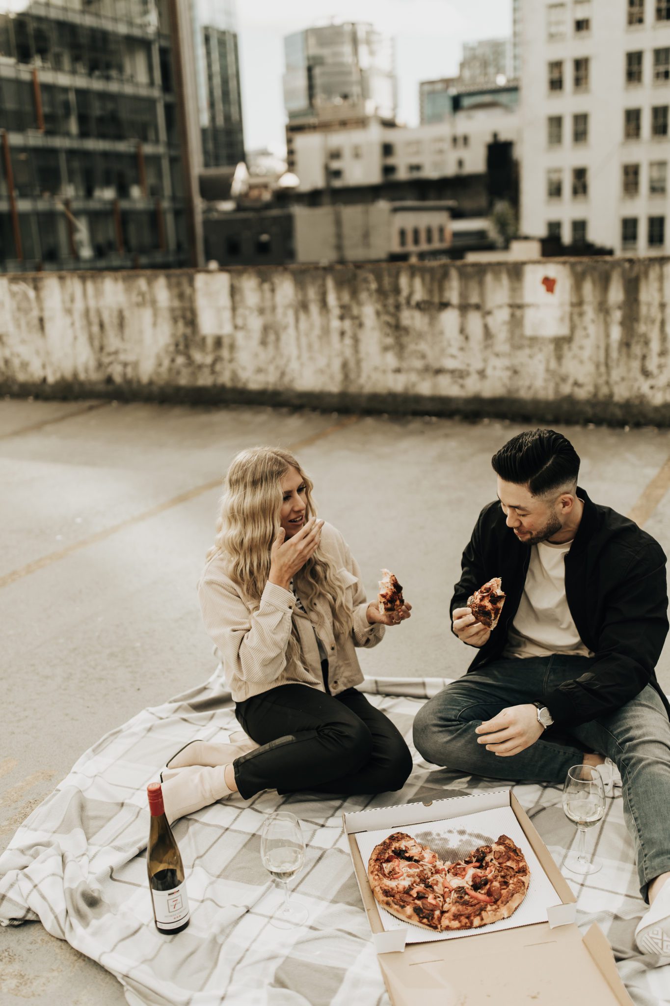 Unique engagement session with pizza and wine on a rooftop in downtown Vancouver