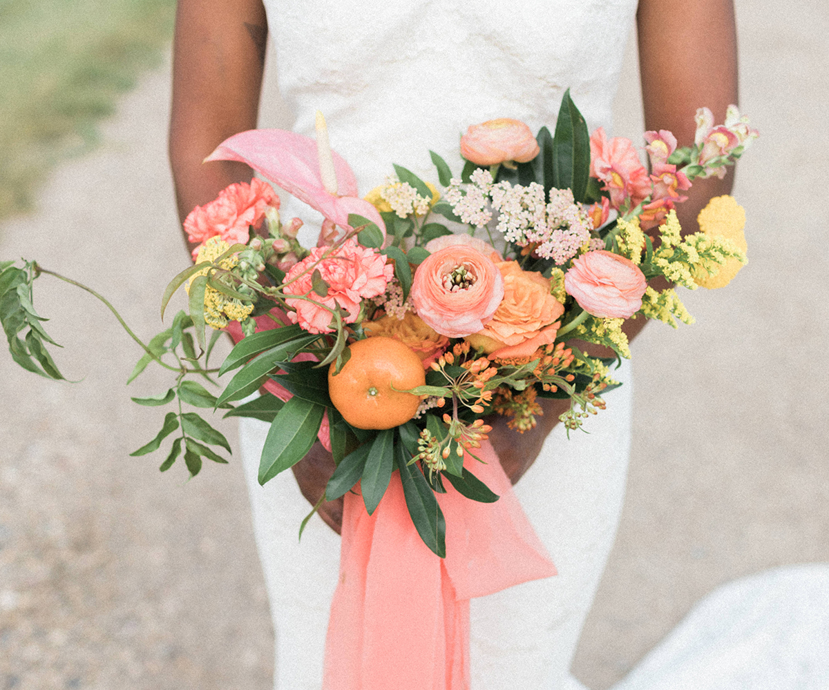 Spring wedding bouquet with orange, pink and yellow blooms