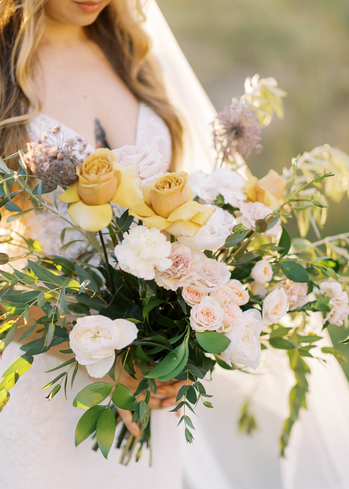Golden roses in a nature inspired wedding boquet