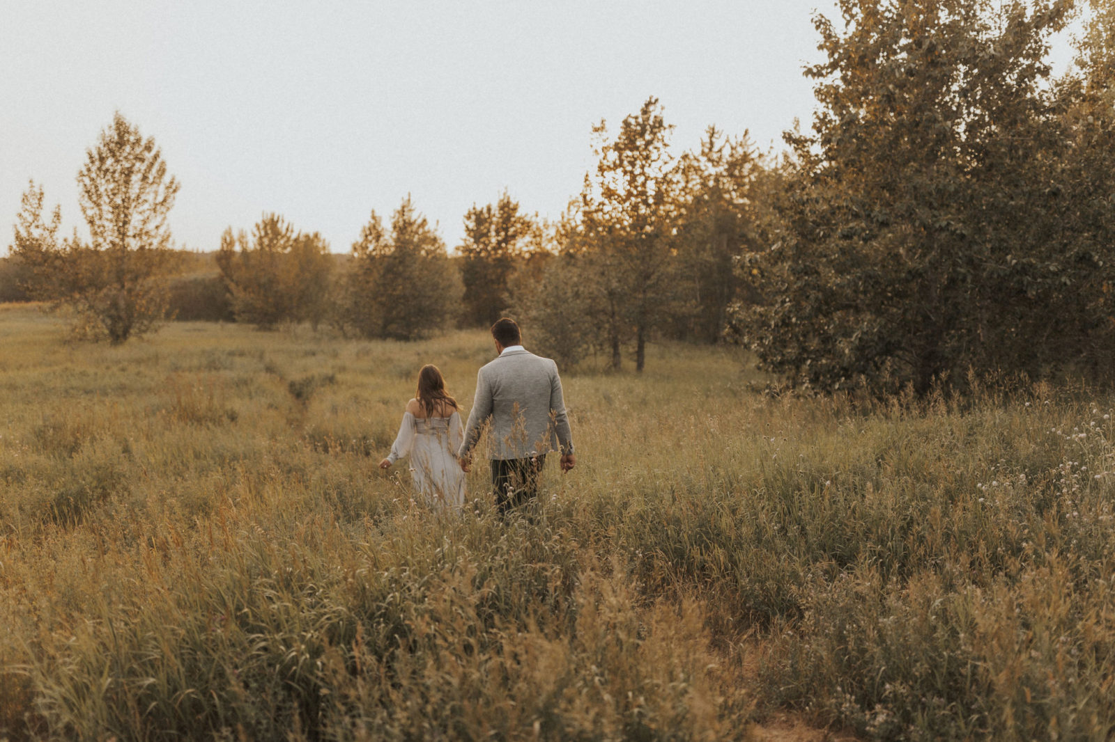 Sunset engagement session in a dreamy field