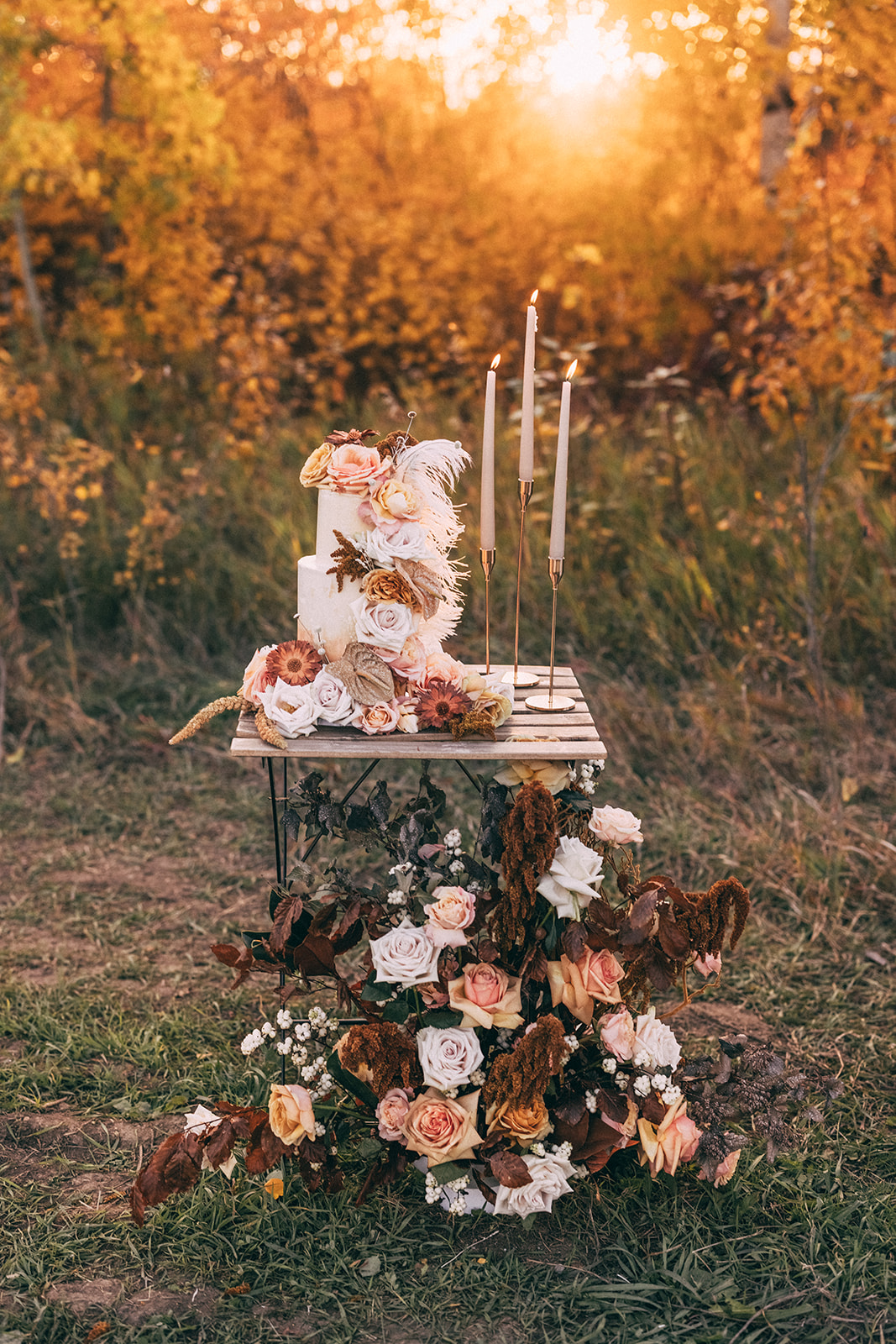 Boho two tiered wedding cake adorned with fall flowers by The Art of Cake