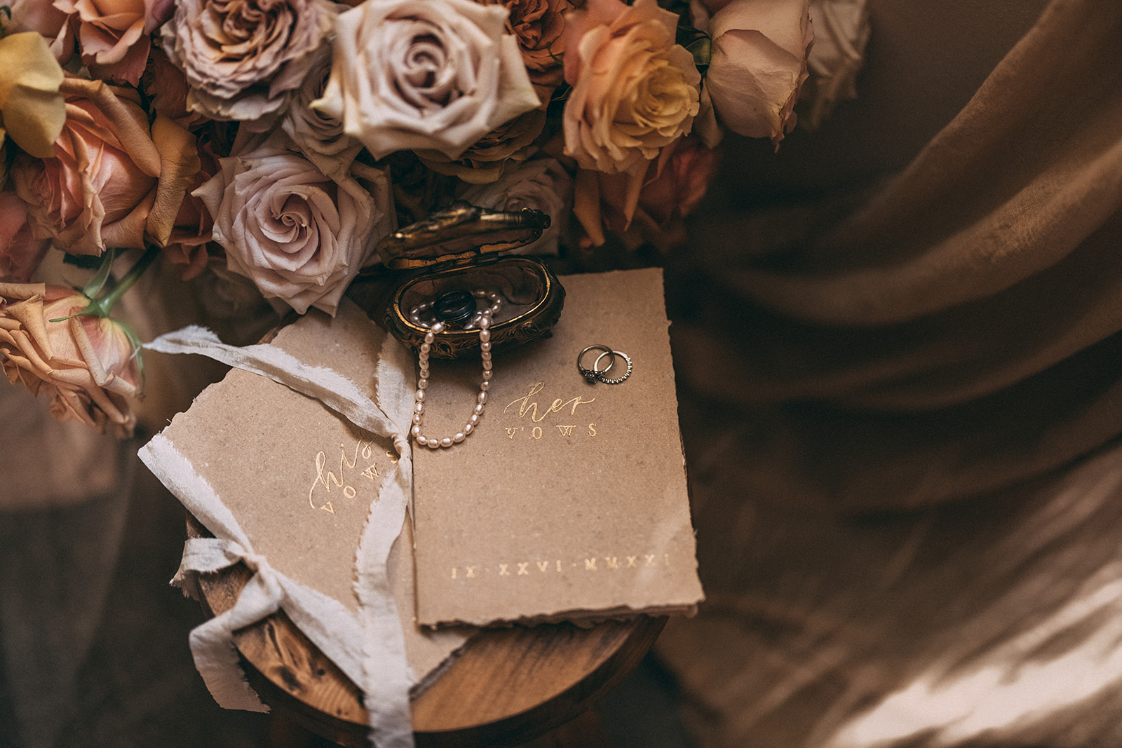 Autumnal wedding day details in neutral tones with vow booklets