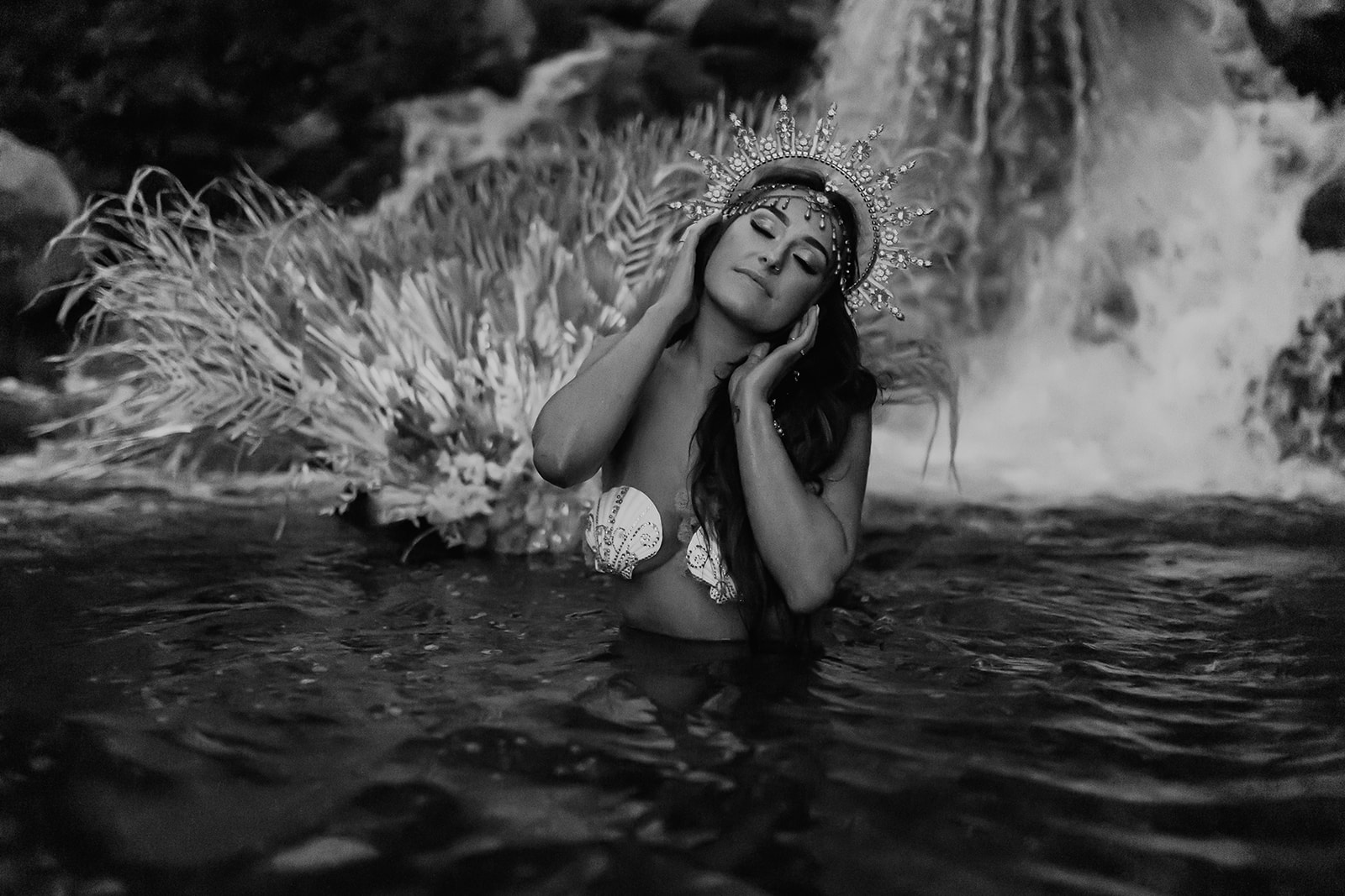 Siren in a waterfall with seashells in her hair