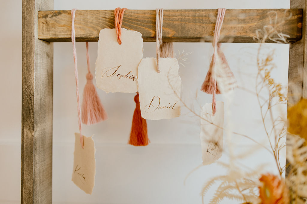 Escort card display inspiration on paper tags with beautiful script
