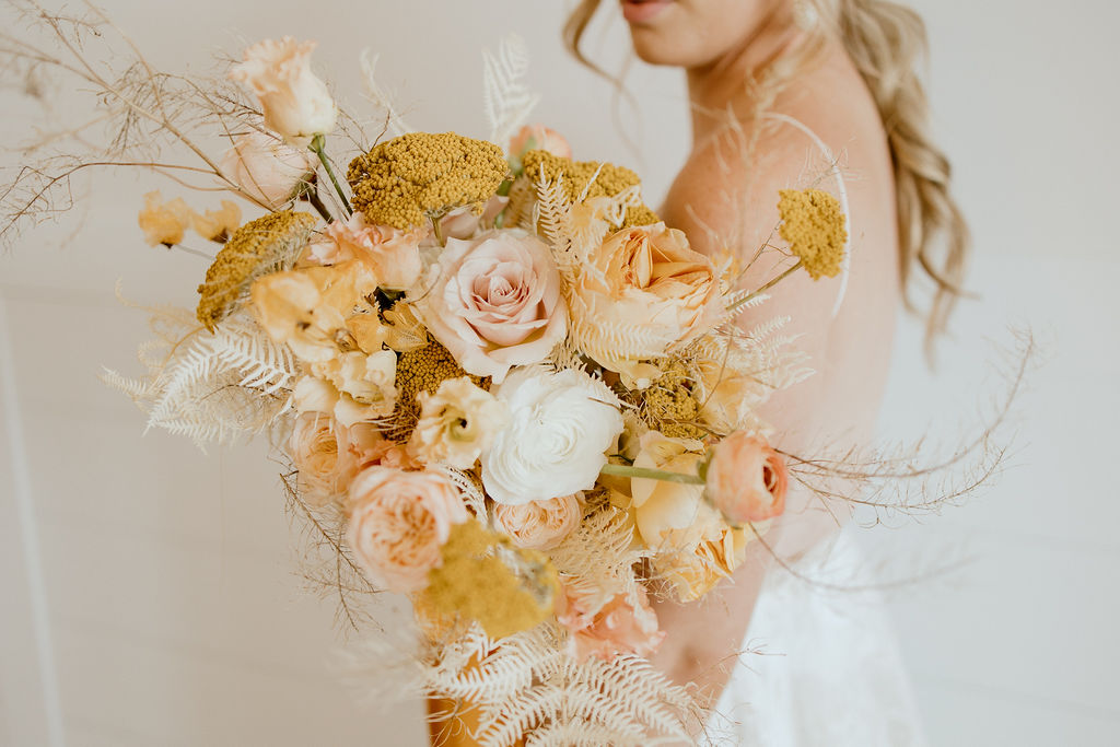 Fall wedding bouquet inspiration with cream, peach, white, yellow and orange blooms