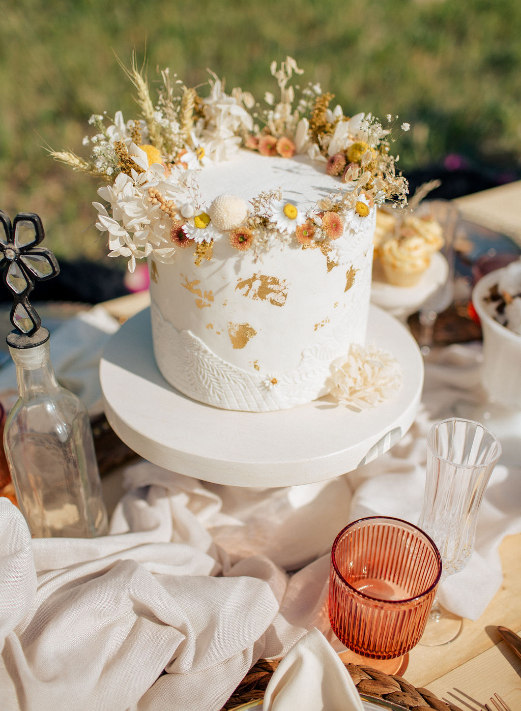 Wedding cake adorned with wildflower crown