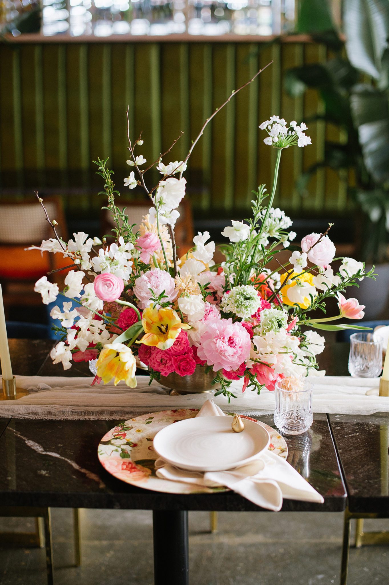 Bright spring floral table arrangement for a tropical inspired wedding